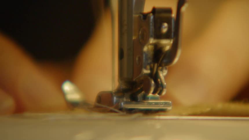 The person is operating a sewing machine