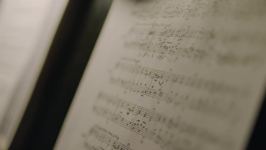 A close up view of some sheet music on a stand