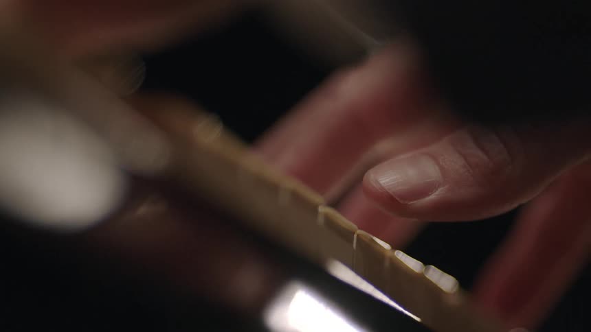A hand plays a piano