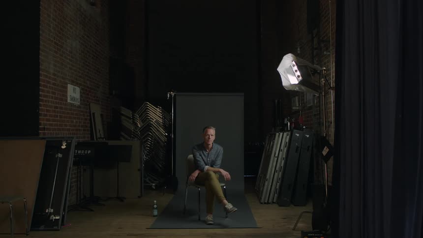 A man is sitting in a studio