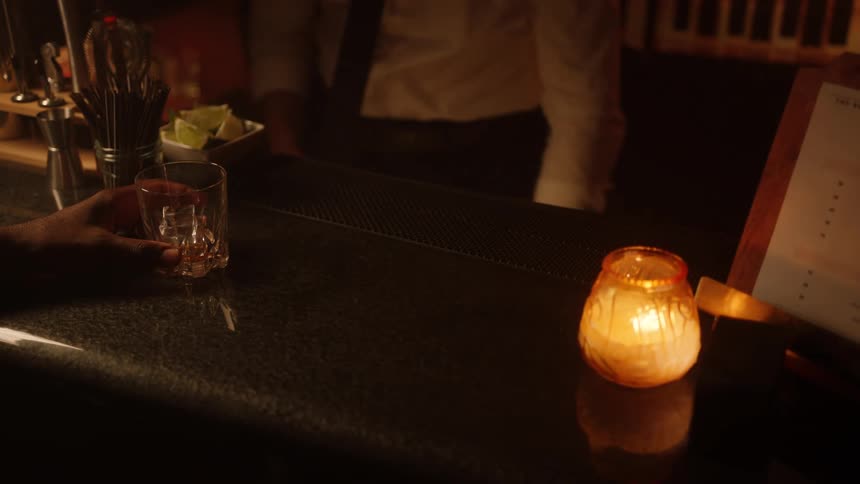 Customer puts a credit card on top of his bar tab and the bartender puts it in a processing machine