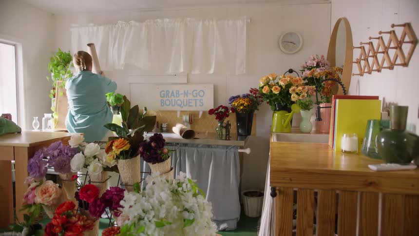 The woman is arranging flowers in the flower shop