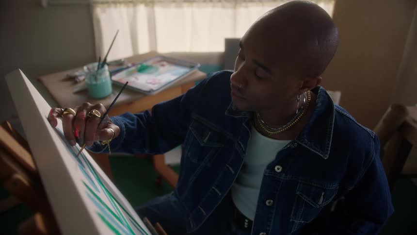 A man painting on a canvas