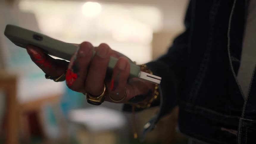 Woman holds a processing machine and swipes a credit card