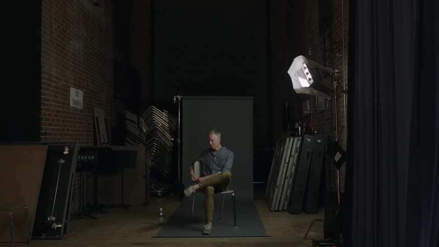 Man sitting alone in a dank setting indoors