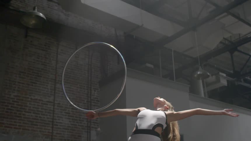 Woman twirls a hula hoop around