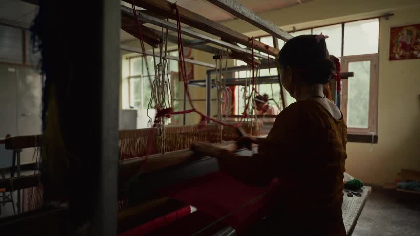 A woman working on a loom