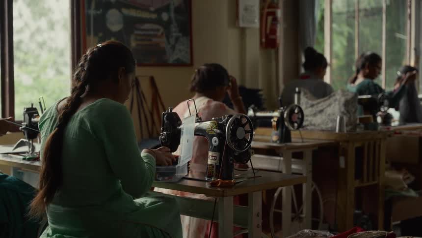 A group of people working at sewing machines