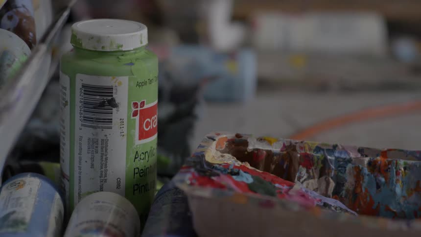 Paint bottles are all over this table