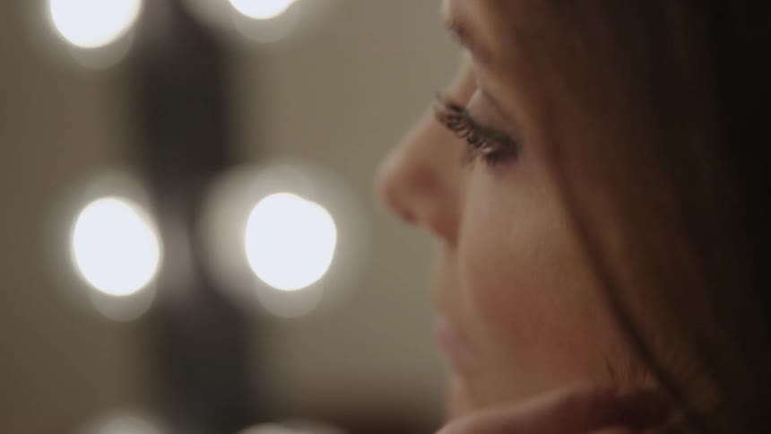 A woman puts makeup on