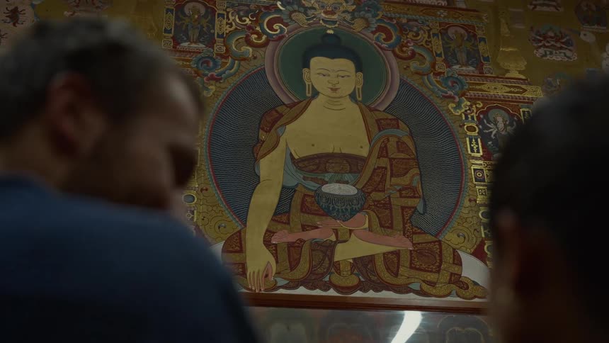 A man and woman talk in the temple