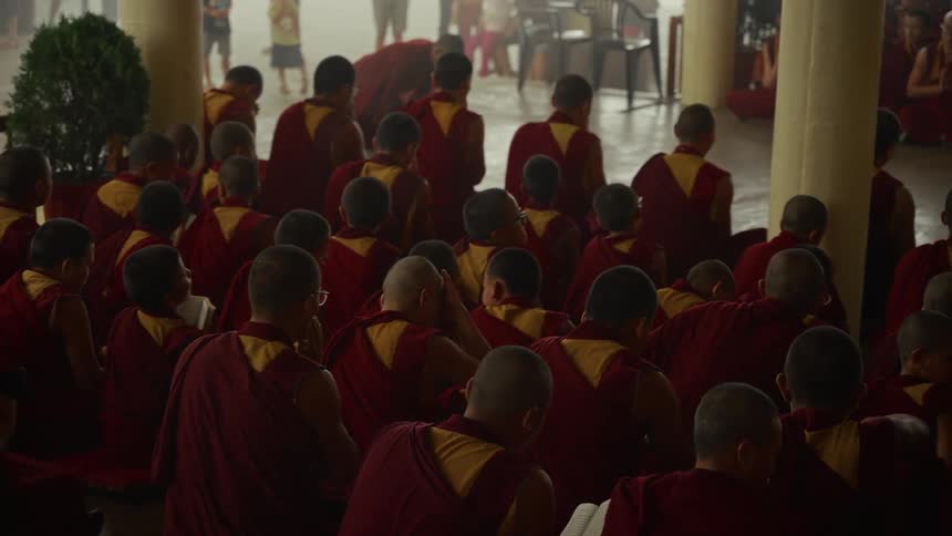 The monks pray together in the temple