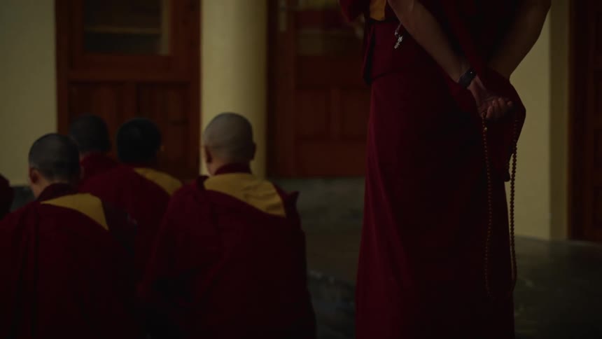 The monks sit together in the temple