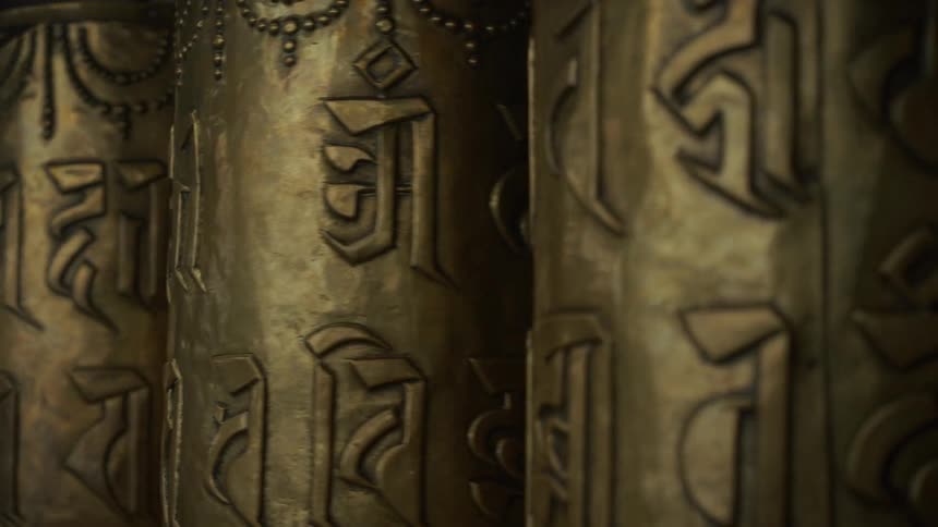 Rolls with symbols etched into them rotate