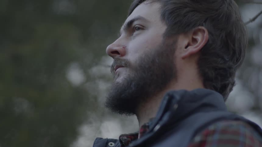 Man in the forest looks out