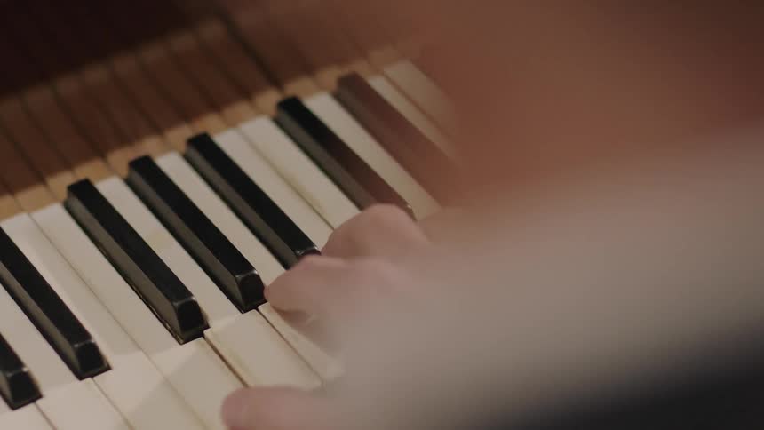 A man is playing the piano