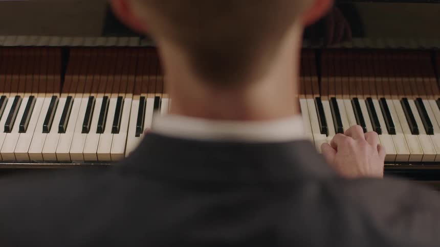 A man plays a piano