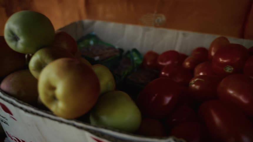 Display of fresh fruits and vegetables featuring colorful apples red peppers and citrus prominently