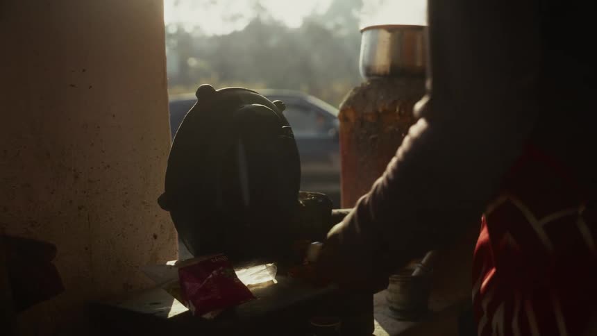 A person cooks by spinning a device