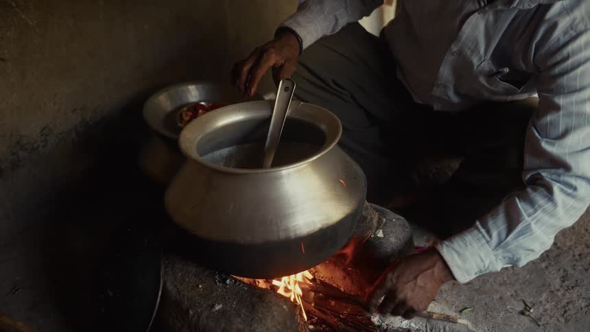 A person cooking food in a pot