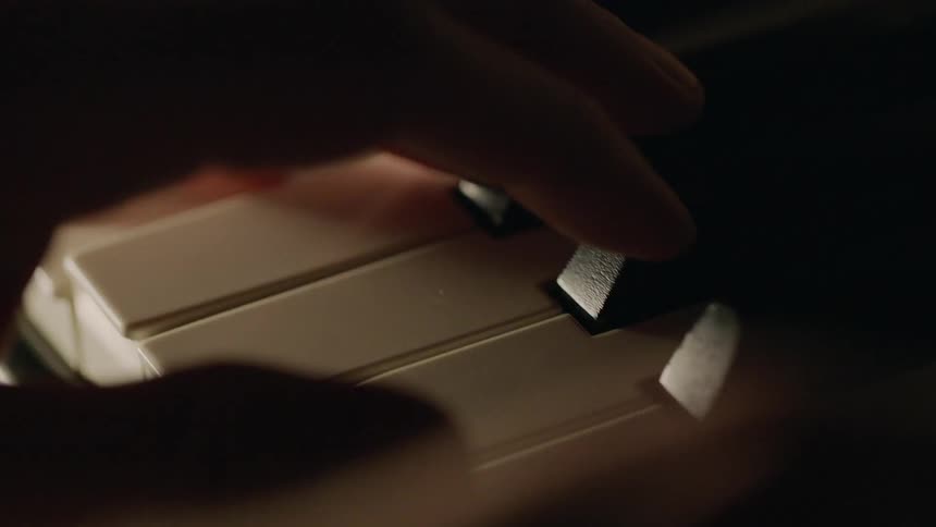 Person's hands playing a piano