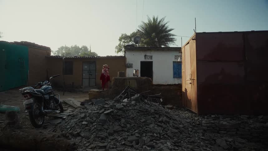 The woman walks towards the shelter