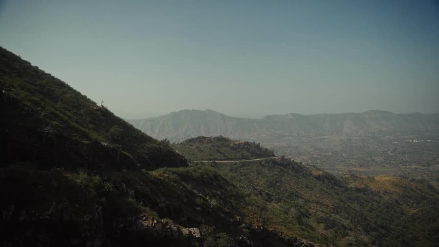 The tall mountains are covered with green
