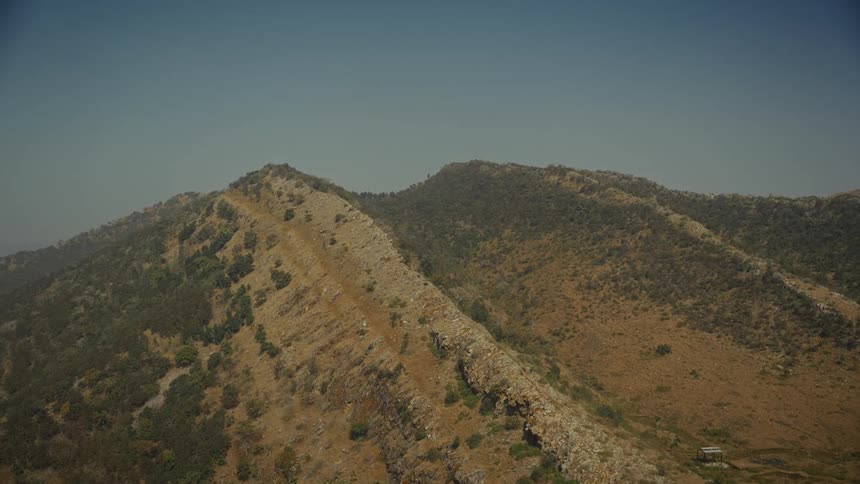 Peaks on a mountain range area next to a valley outdoors during day time