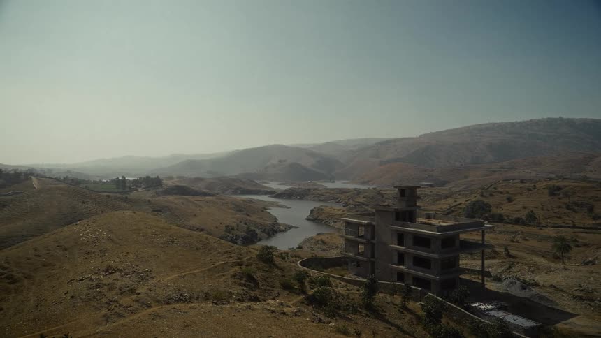 A view of a building outdoors in a valley