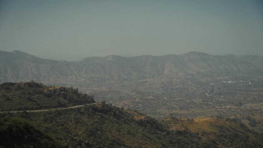 A view of a mountain and valley on a sunny day