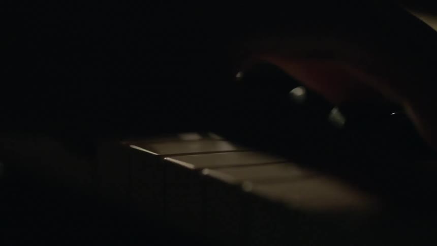 Close up of fingers pressing piano keys