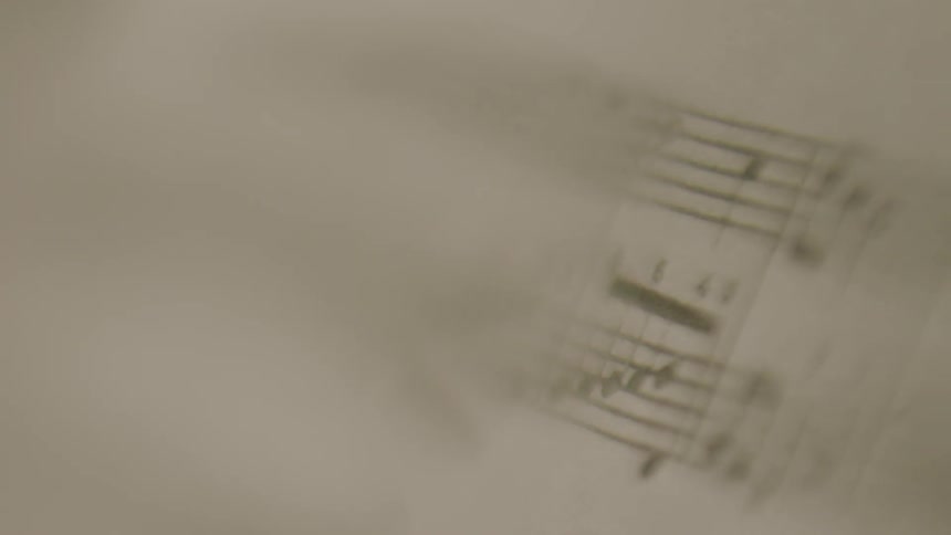 Musical notes and bars on sheet music blur