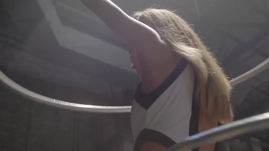 A woman is twirling hula hoops around her body