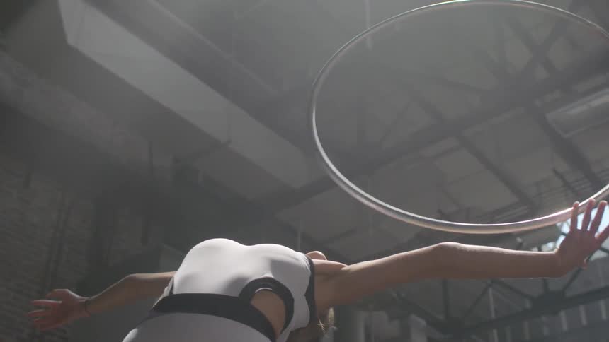Woman twirls a hula hoop around