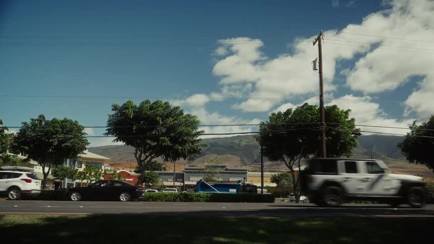 Traffic travels on the small town road