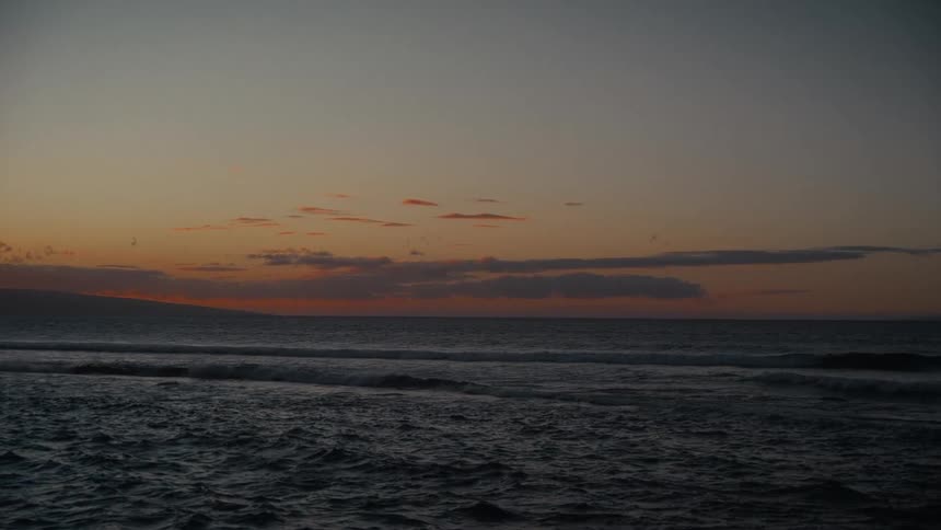 The water is rough as the sun rises