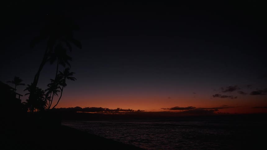 The sun is rising on the shore line