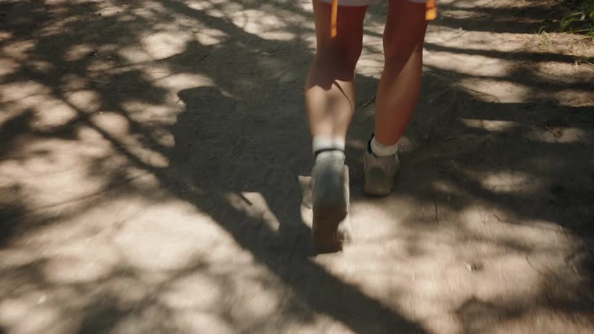 The person is hiking on a sunny day