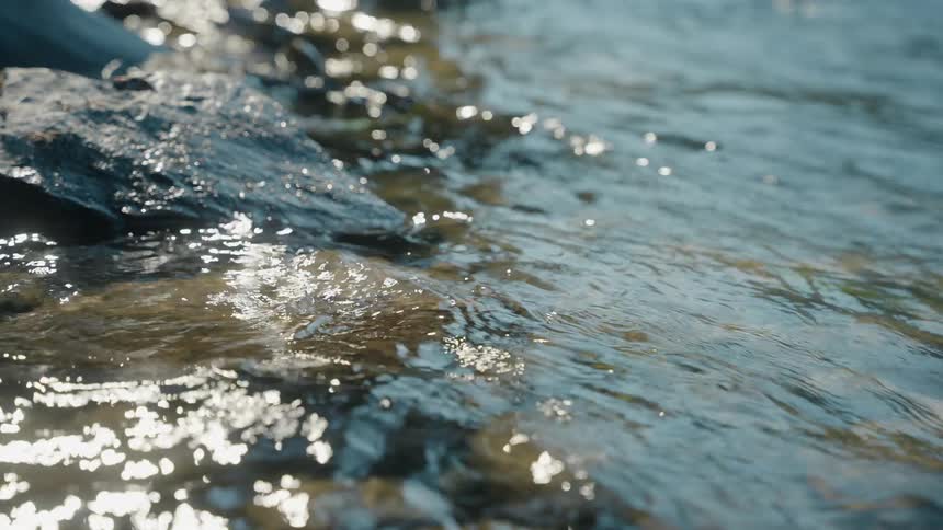 The sunlight is reflecting on the stream water