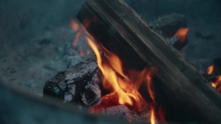The logs are burning in the campfire