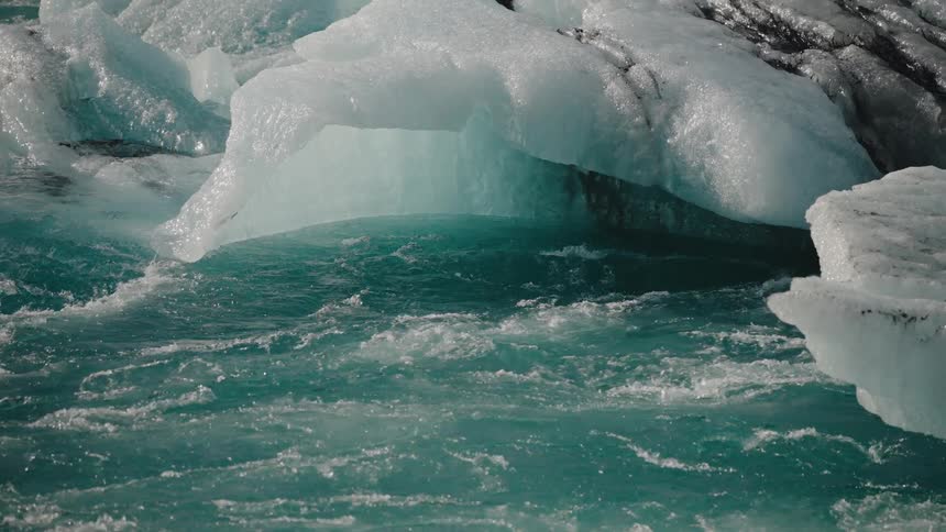 Water flows as icebergs melt along the coast