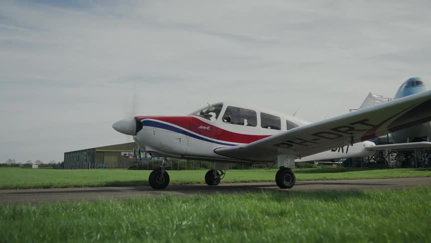 Propeller spinning on a small airplane sitting in a field