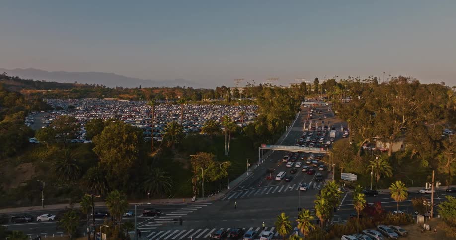 Crowded parking lot with heavy vehicle traffic near stadium