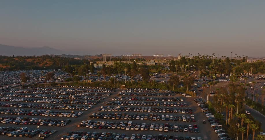 A large city car park is filled with cars at midday