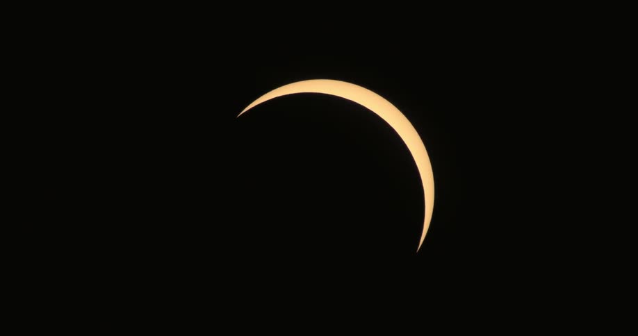 A quarter sun is in a dark sky
