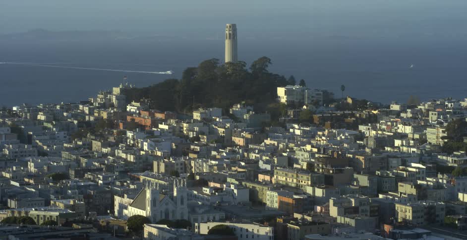 The city leads to a tower on the hill by the water