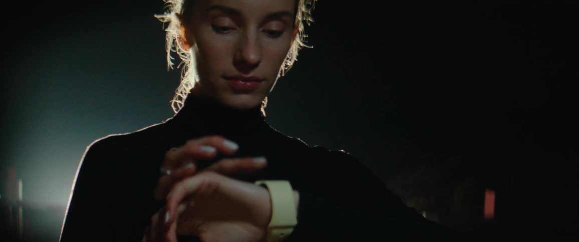 A woman using a watch outdoors