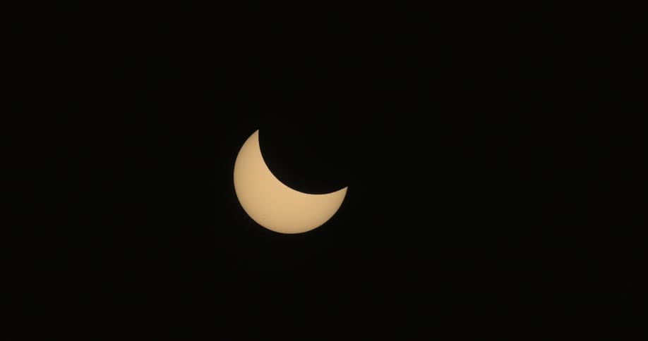 A crescent sun moving with a black background