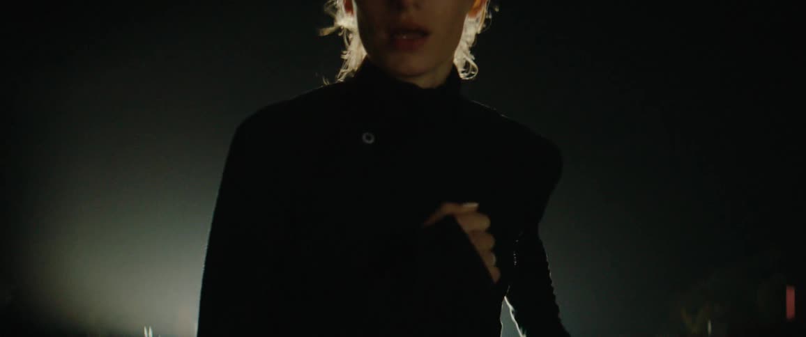 A woman running outdoors at night