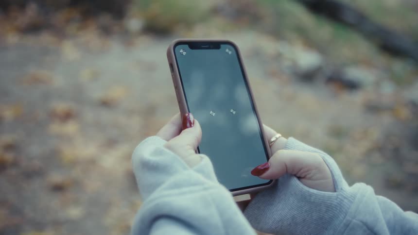 A woman using a smartphone outdoors